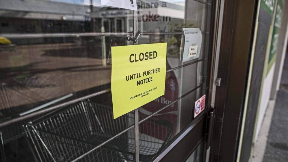 Photo of a sign placed at the front of a shop saying 'Closed until further notice'